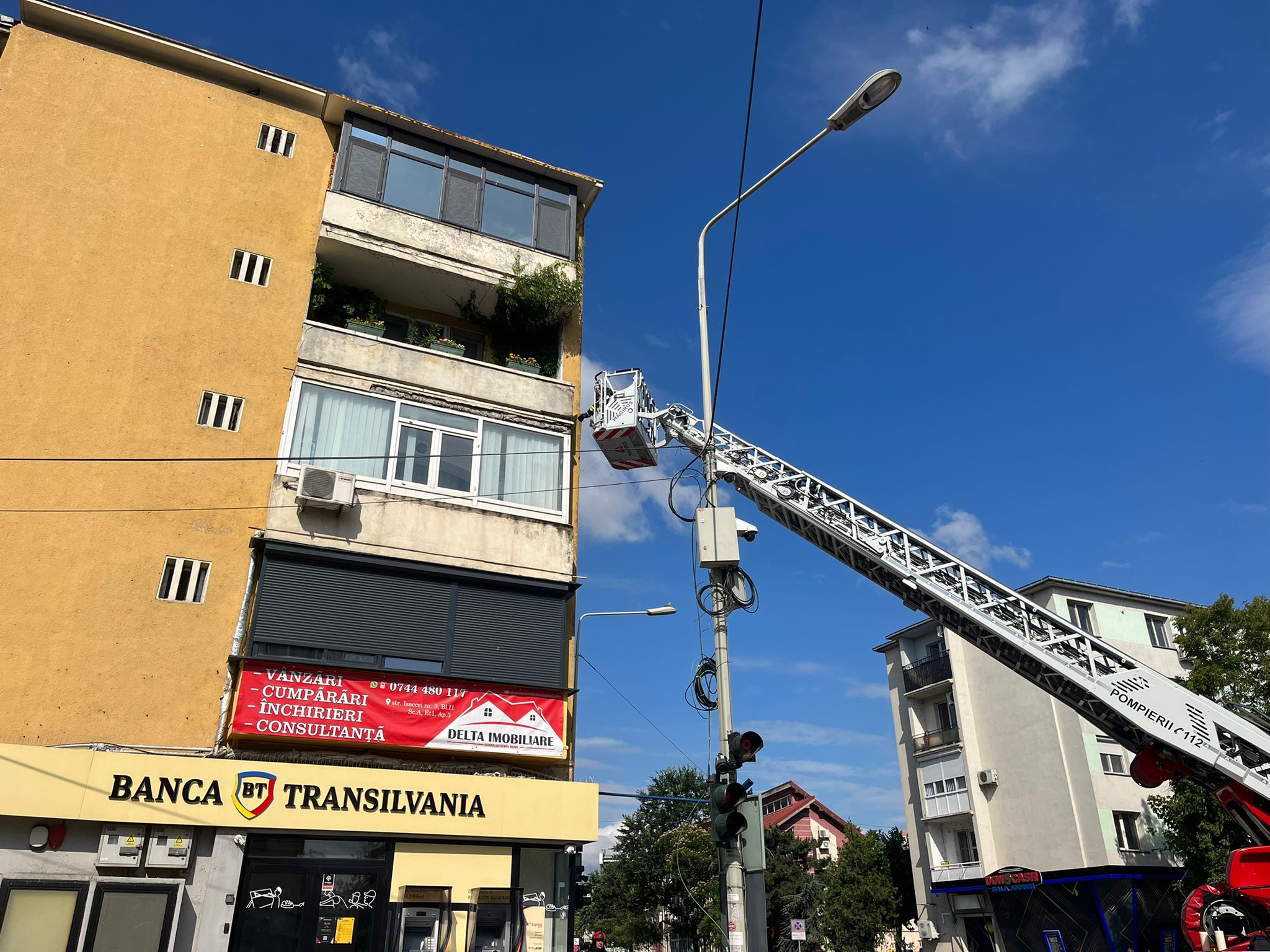 (FOTO/VIDEO) Bucăți de tencuială riscă să se desprindă de pe fațada unui bloc din Tulcea. Pompierii intervin cu o autoscară